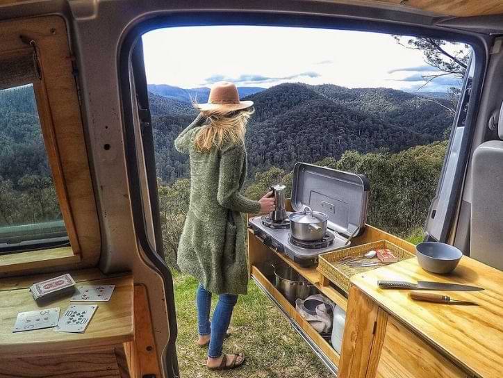 A lady enjoying outside kitchen in campervan